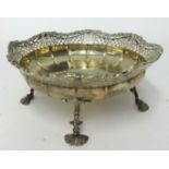A George V silver and pierced dish on four legs with fan feet, approx 14.56oz, diameter 19cm.