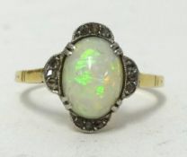 An 18ct opal and diamond set dress ring in yellow metal, ring J1/2