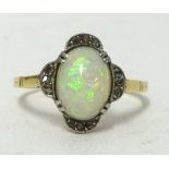 An 18ct opal and diamond set dress ring in yellow metal, ring J1/2