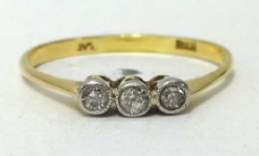 An 18ct three stone diamond ring (small diamonds), ring size V1/2