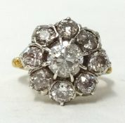 A diamond cluster ring set with a round European cut diamond, complete with copy of insurance