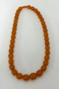 An amber style necklace, approx 128gms, length 70cm.