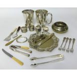 A collection of silver plated wares, including salver, tankards, napkin rings, flatware, objects