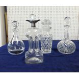 A silver mounted glass decanter and three others.