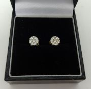 A pair of diamond cluster earrings, set in yellow and white 18ct gold.
