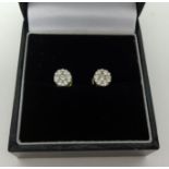 A pair of diamond cluster earrings, set in yellow and white 18ct gold.