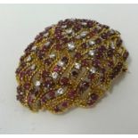 A highly ornate 18ct ruby and diamond brooch, approx 50mm x 39mm.