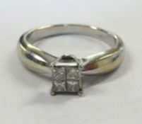 A 14k four stone diamond ring