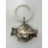 An antique silver fish teething ring/rattle.