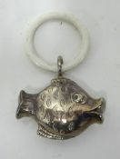 An antique silver fish teething ring/rattle.