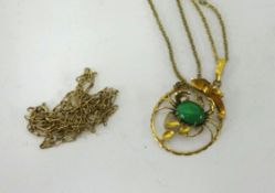 A yellow metal insect pendant set with green stone and two fine chains.