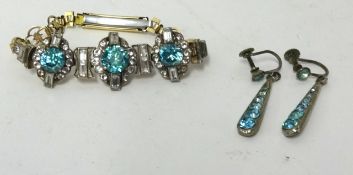 A vintage stylish bracelet and a pair of drop pendant light blue stone earrings.