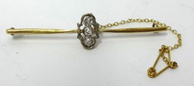 An 18ct gold brooch set with three old cut diamonds approx 3.6gms.