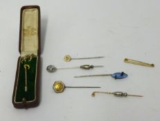 Eight assorted gold and other tie pins.