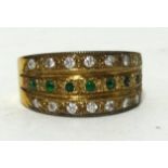 An emerald and diamond set three row band ring in yellow metal, approx 9.10gms, ring size J1/2