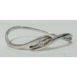 A 18ct white gold and diamond set bangle of contemporary twist style, approx 19.6gms.