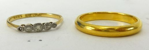 A 22ct gold wedding band together with a 18ct gold ring set with five small diamonds (weight of