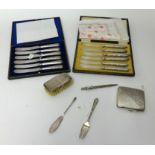 A collection including cased set of six George V silver handle knives, London 1934, case set of