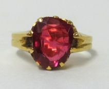 A high carat dress ring set with red stone, finger size M.