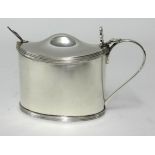 A silver mustard pot, with blue glass liner Birmingham 1930, SB & S Ltd (silver weight 4.67oz).