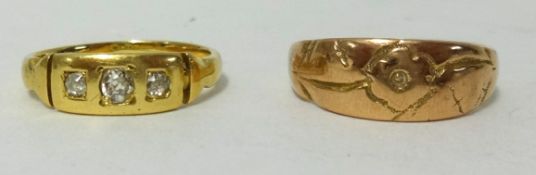 An antique yellow metal ring, another yellow metal and three stone diamond set ring (no