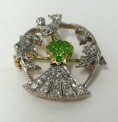 A diamond and emerald set thistle brooch.