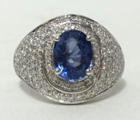 A 14k white gold and diamond ring set with an oval cut unheated blue sapphire approx 2.63ct,