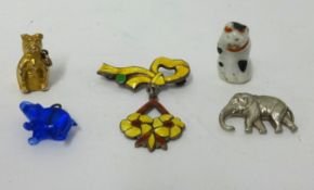 An enamelled brooch and four various charms, including 9ct gold bear.