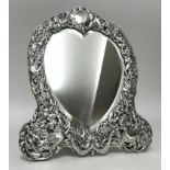Victorian silver heart shape dressing table mirror richly decorated in birds, and scrolls with