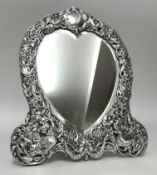 Victorian silver heart shape dressing table mirror richly decorated in birds, and scrolls with