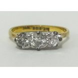 A diamond three stone ring, indistinct hallmark, probably 18ct, finger size O.