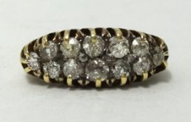 An antique 18ct diamond double band and claw set ring, set with 12 old cut diamonds, ring size L