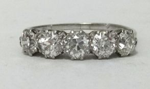 An 18ct platinum diamond five stone ring, total weight approx 1.67cts, with copy of insurance