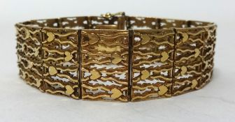 A 9ct gold textured hinged bracelet approx 33.5 gms, length 19cm.