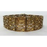 A 9ct gold textured hinged bracelet approx 33.5 gms, length 19cm.