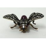 A fine antique insect brooch set with a cabochon ruby, a sapphire and old cut diamonds, wing span