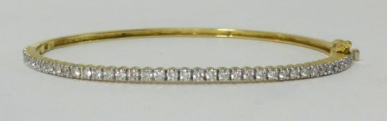 An 18ct diamond set bangle (approx 40 diamonds).