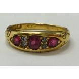 An antique 18ct gold ruby and diamond ring, set with three ruby's and four old cut diamonds