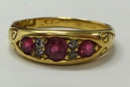 An antique 18ct gold ruby and diamond ring, set with three ruby's and four old cut diamonds