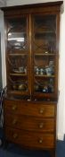 A 19th Century mahogany bookcase, the upper section with circular astragal glazing bars and two