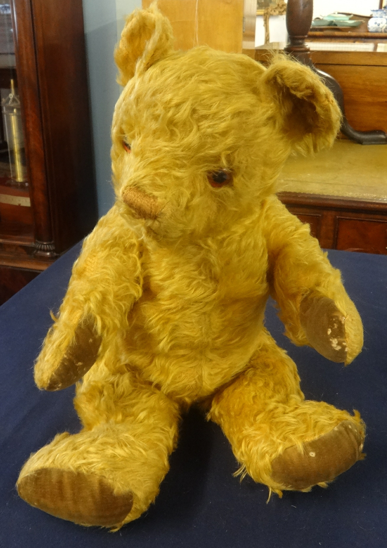 An English teddy bear circa 1930/40, with amber glass eyes.