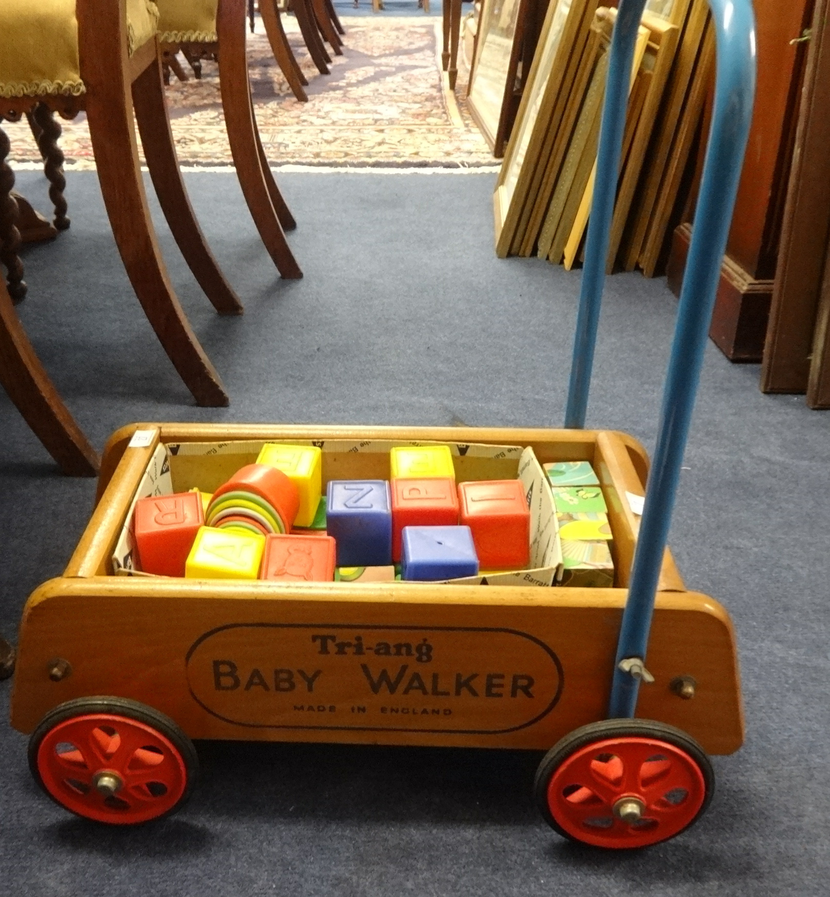 A Triang sit on train and original push along Triang baby walker with bricks.