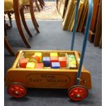 A Triang sit on train and original push along Triang baby walker with bricks.