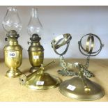 Two brass gimbal oil lamps.