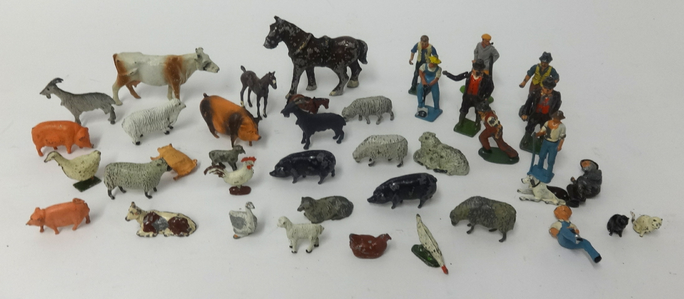 A collection of Dinky farmyard lead figures and diecast farmyard models including police car.