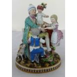 A Meissen porcelain figure of a family group in period costume sat upon a settee with a dog, with