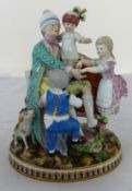 A Meissen porcelain figure of a family group in period costume sat upon a settee with a dog, with