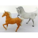 Two Beswick horses, a Palomino and a grey racehorse (2).