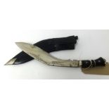 A Kukri knife with leather scabbard and two small carving knives.