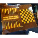 A late Victorian rosewood and inlaid games table with fold over top, decorated with a chessboard and